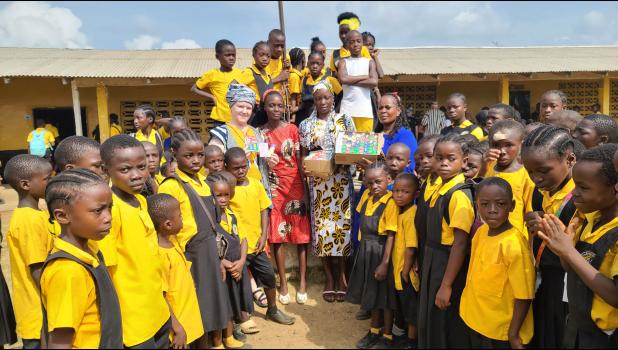 Roxy gifting the kids crayons and coloring books. Courtesy Photo
