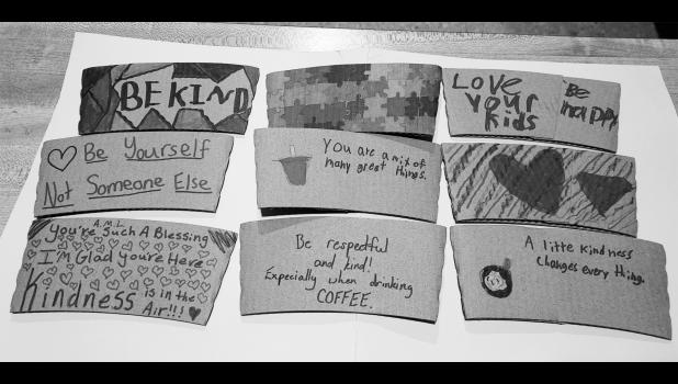 Coffee sleeves decorated by K-6th graders for World Kindness Day. Photo by Krisanna Thomas