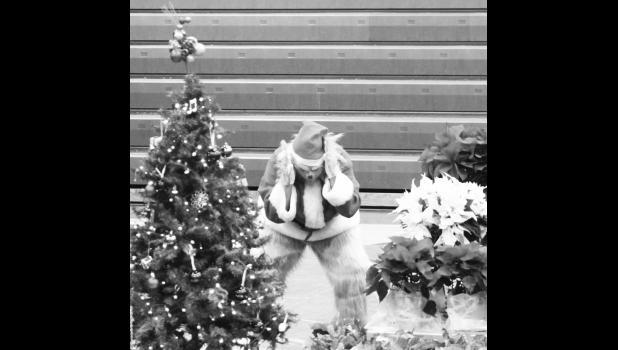 The Grinch trying to fight the Christmas spirit. The Christmas concert spotlight was nearly stolen by the Grinch. Photo by Mishayla Buchannan