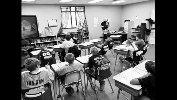 Mike McKernan and Kit Talich demonstrate gun safety. Courtesy photo