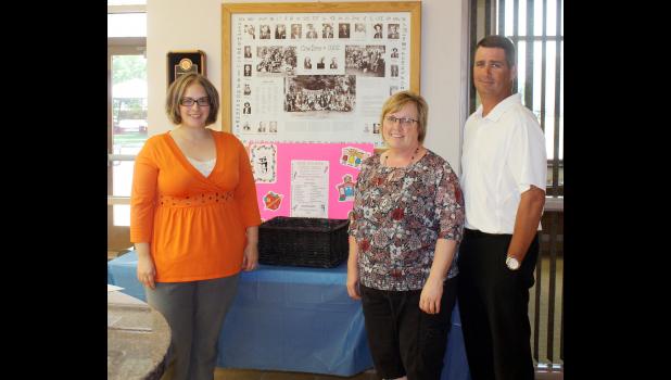The big, bright box at the bank is beckoning to be filled with more school supplies to be given to Haakon School District students. From left are drive organizers Neville, Schulz and Reedy.