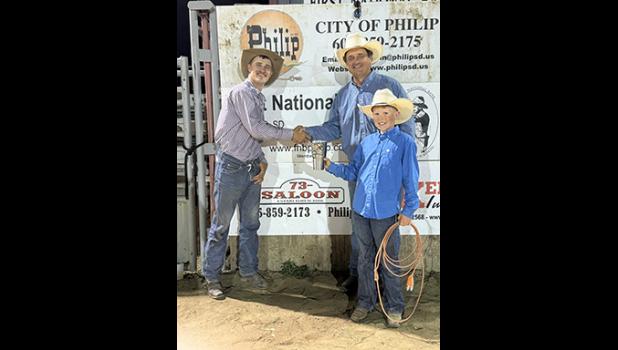 Cooper West, one of the organizers and contestants congratulated Wilson’s Muddy Creek with the Contractor’s Cup Trophy. Plooster Photography