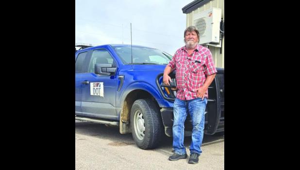 Joel Larson, Heart of the Township, leans against his SD DOT truck — a man who’s spent nearly 40 years keeping Rainbow Township’s roads in shape. Submitted photo