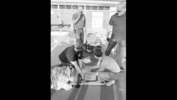 Beth Newbold and Blake O’Dell reenact a scenario of dealing with a spinal injury on Sunny Valburg. Photo courtesy of the Jones County Ambulance Service Facebook page