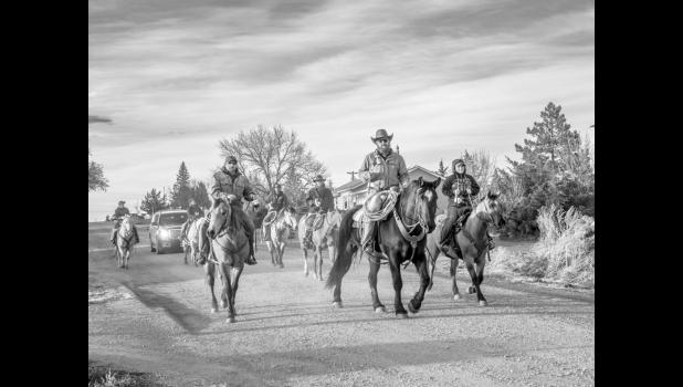 A group of horseback riders ride through Murdo, S.D. on April 18, 2025. Photo by Barb Hockenbary Photography