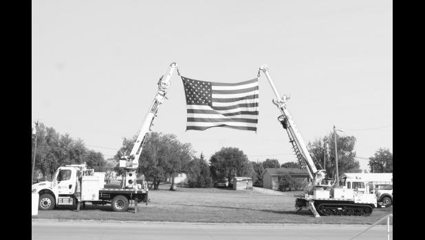 The American flag was held high on display by two of WCE’s electric trucks outside of the Harold Thune Auditorium. Photo by Mishayla Buchannan