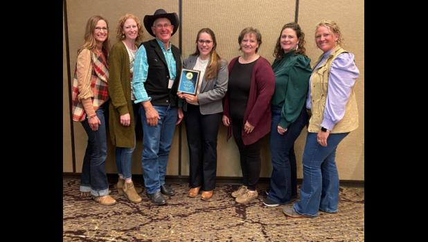 Kelly Froehlich, assistant professor and SDSU Extension Sheep and Goat Specialist, at center, presents the Master Lamb Producer Award to the Anderson family, owners of Darling Creek Ranch, LLC. Anderson family members pictured, from left, Danci, Danika, Dan, Sharon, Dantae and Danessa. Photo courtesy SDSU Extension Jones/Mellette County 4-H