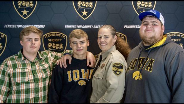 Lisa with her three boys. Lisa followed in her parents’ footsteps when entering into law enforcement.