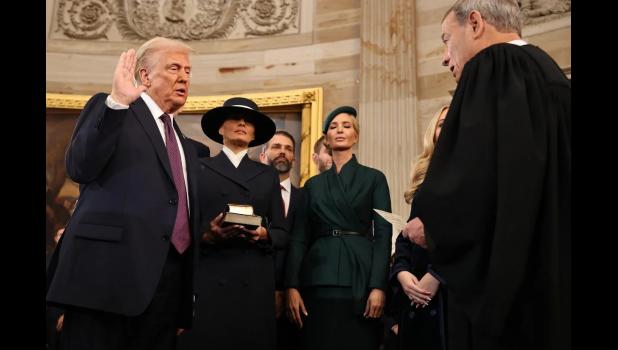 President-elect Donald Trump takes the oath of office from U.S. Supreme Court Chief Justice John Roberts, as Melania Trump holds two Bibles by his side. GETTY IMAGES