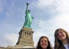 Lilli Moore and Emily Jacobs pose beside New York City’s Statue of Liberty.