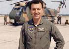 Capt. John G. Piroutek on the flightline, in front of his helicopter.